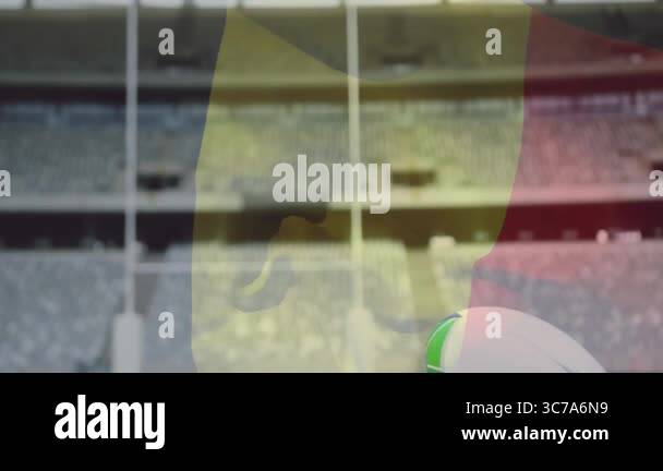 In stadium, rugby ball on kicking tee with goalposts in background ...