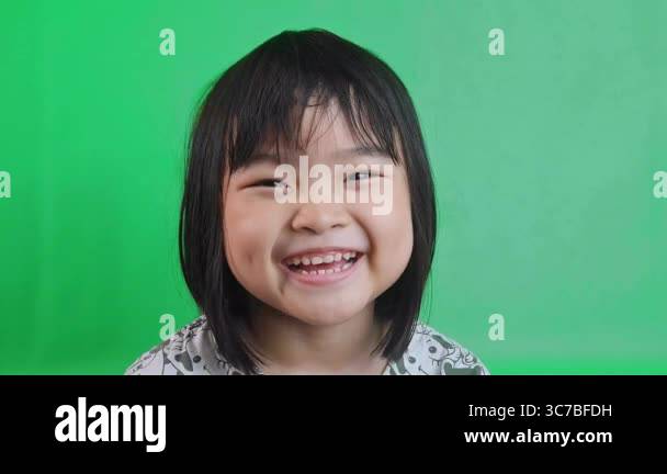 asian little girl laughing happily, isolated with green screen ...