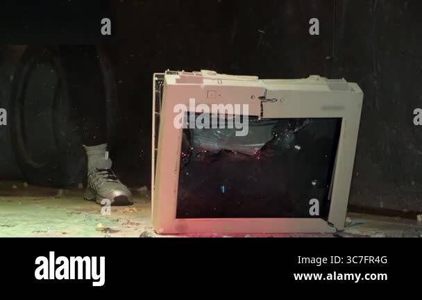 Old computer monitor being smashed by an axe during an intense moment ...