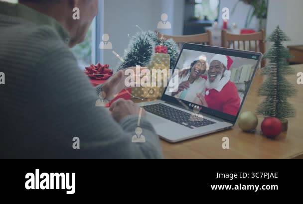 Video calling couple in Santa hats, man using animation with digital ...