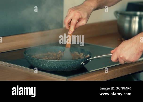 Stirring seafood mixture in frying pan with spatula. Mixing mussels ...