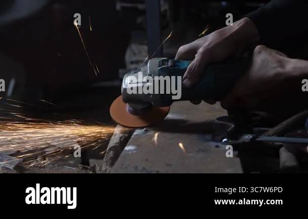 close up of man's hand grinding without using safety gloves. unsafe ...