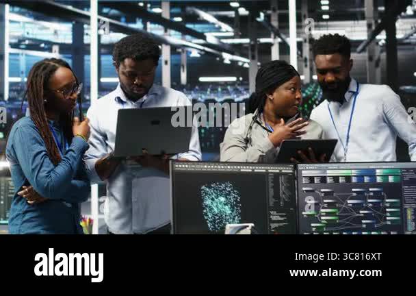 Portrait of smiling data center specialists collaborating in server ...