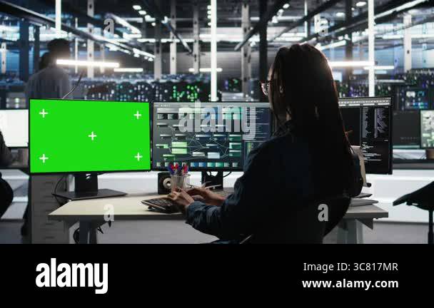 Data center technician using node tree software on green screen PC to ...