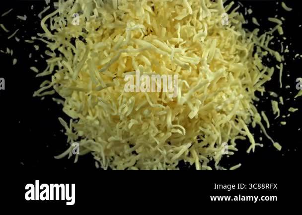 The grated cheese flies up and down. Filmed on a high-speed camera at ...