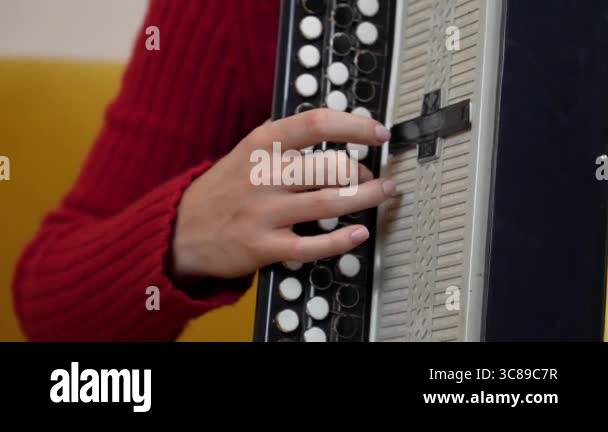 a close-up showing hands of musician skillfully playing traditional ...
