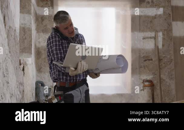Confused puzzled construction builder worker on a renovation building