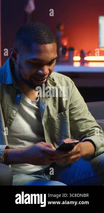 Vertical Video African american person texting messages on a smartphone ...