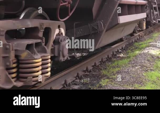 Close-up of freight train rolling stock. Low-angle close-up of steel ...