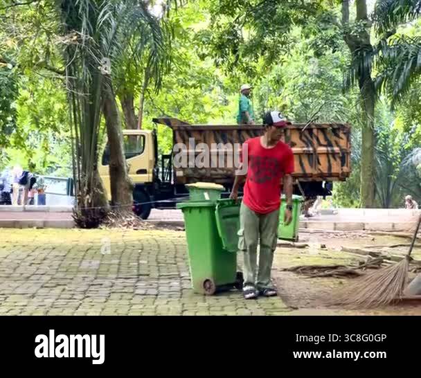 Jakarta, Indonesia - May 13 2025 : Garbage man is taking trash at a