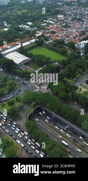 High-angle view of a busy city intersection and highway with heavy ...