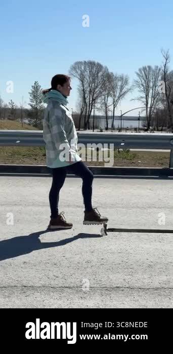 Caucasian woman steps on a rake Stock Video Footage - Alamy