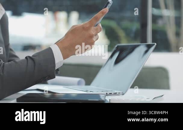 young businessman using smartphone and tablet computer at work Stock ...
