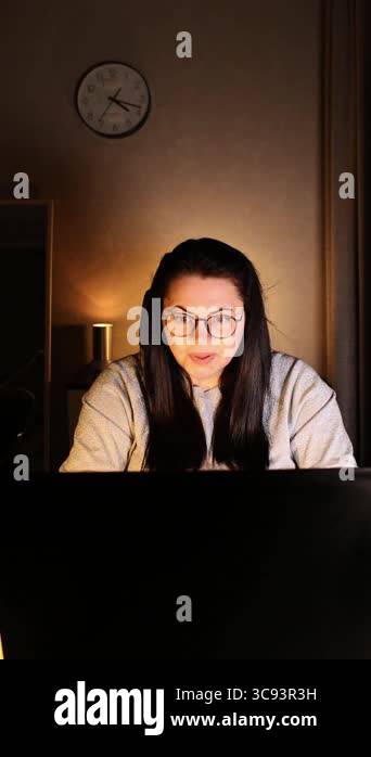 Woman sitting at desk and have video call with beloved people living ...