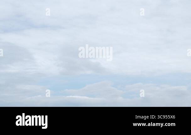 clear blue sky with a few clouds. The sky is very bright and the clouds ...