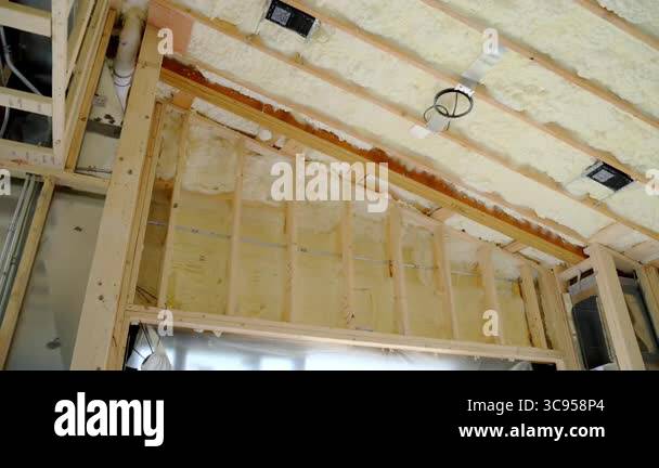 Fiberglass insulation installed between wooden wall studs in the house ...