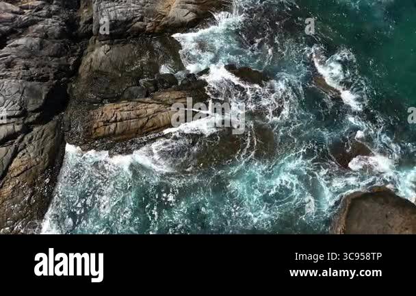 Rocky shoreline where the waves are dramatically crashing against the ...