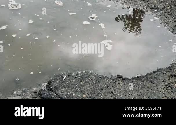 puddle with reflection. reflection in a puddle. Closeup of rain drops ...