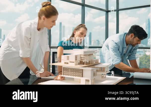 Architect engineer team working together to analyze house model ...