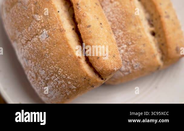 Freshly toasted fluffy wheat buns on a kitchen plate. Cracked bread ...