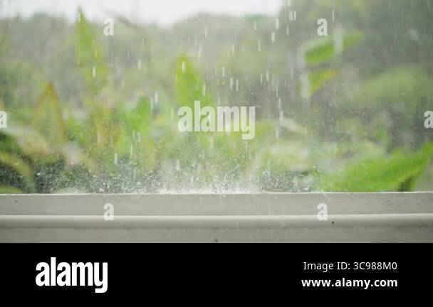 Slow Motion Closeup of Heavy Rainfall Splattering on Concrete Railing ...
