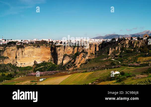 Time lapse. Ronda, old town on hill and green spring valley, panoramic ...
