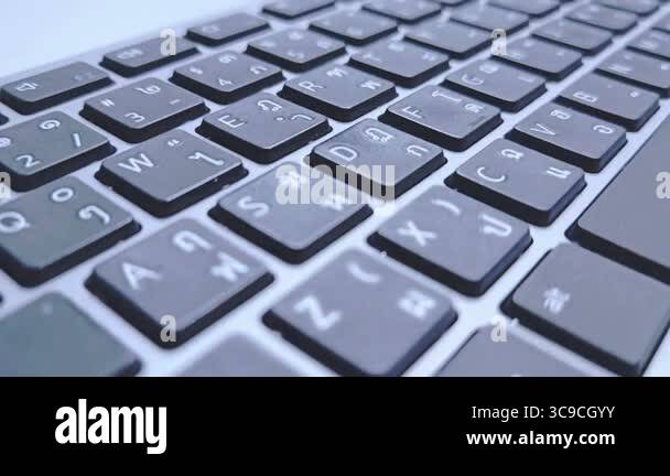 A close-up of a keyboard featuring both English and Thai characters ...