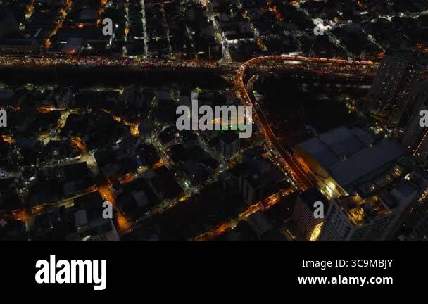Aerial night view of Manila with traffic congestion and brightly lit ...