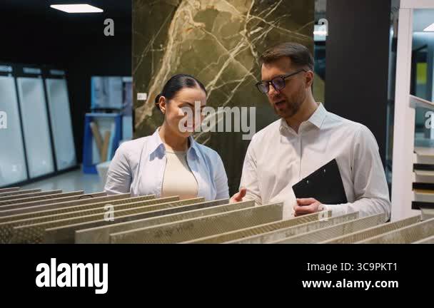 Professional interior designer presenting various tile samples to a ...