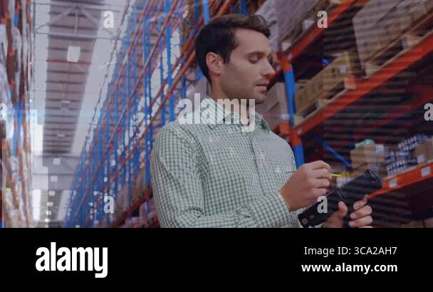 Warehouse operator tapping scanner touchscreen and scanning box ...