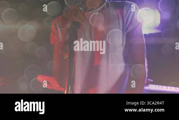 Lead singer holding microphone on concert stage, with animated music ...