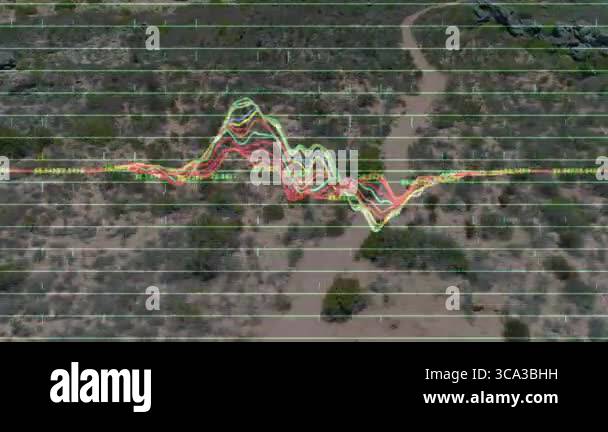 Multicolored waveform graph being projected across desert valley, neon ...