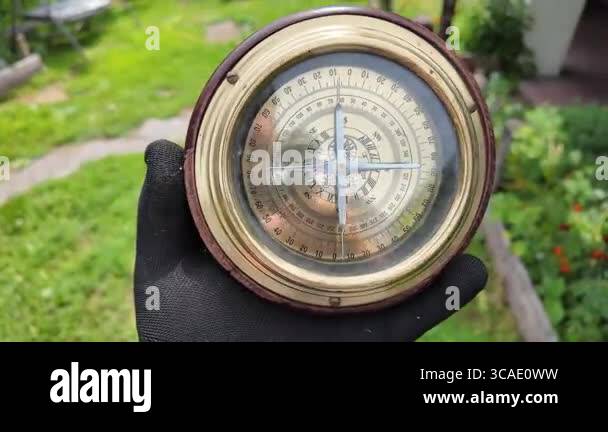 old compass in hands. Man using compass to find location. Close-up ...