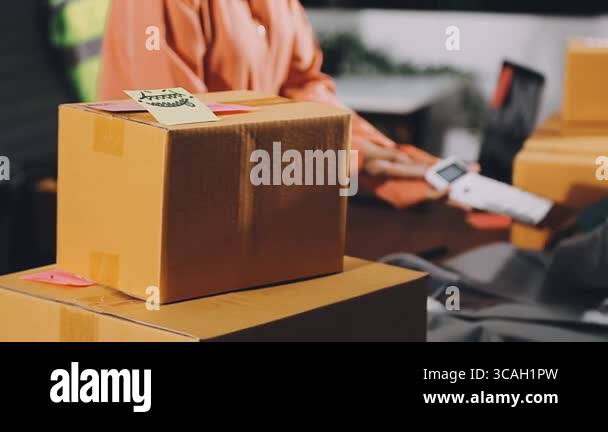 man packing parcel with parcel on the table in the store Stock Video ...