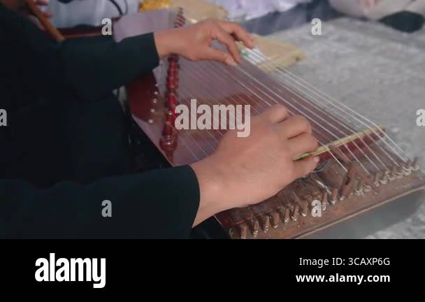 Musicians play the Kecapi (Harp) instrument. Kecapi is a traditional ...