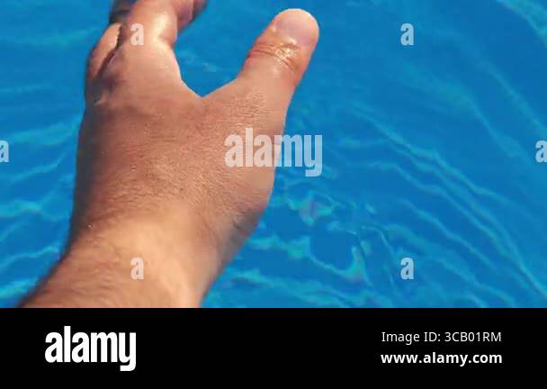Man moving hand in swimming pool water Stock Video Footage - Alamy