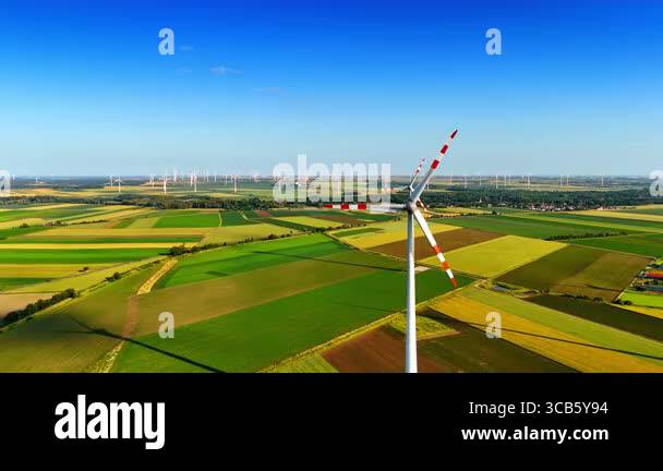Approaching rotating blades of the windmill. Aerial perspective on the ...