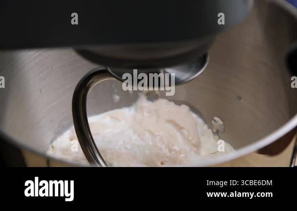 A chef expertly kneading dough in a professional kitchen