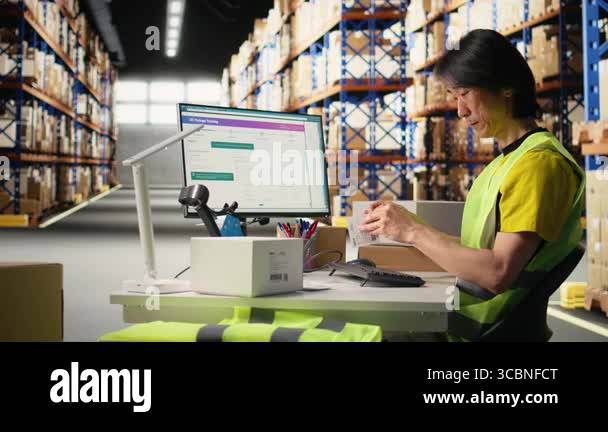 Asian staff manages awb labeling and scanning barcodes before dispatch ...