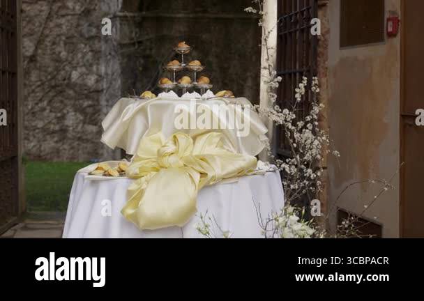 Cupcakes and pastries arranged on a table with a yellow bow, creating a ...