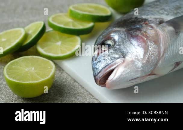 Fresh Raw Dorado Sea Bream Fish with Lime Slices Stock Video Footage ...