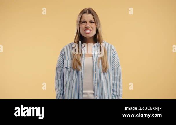 Frustrated model expresses anger and confusion with bold hand motion ...