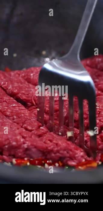 Beef is stir-fried with vegetables in a pan, showcasing vibrant colors ...