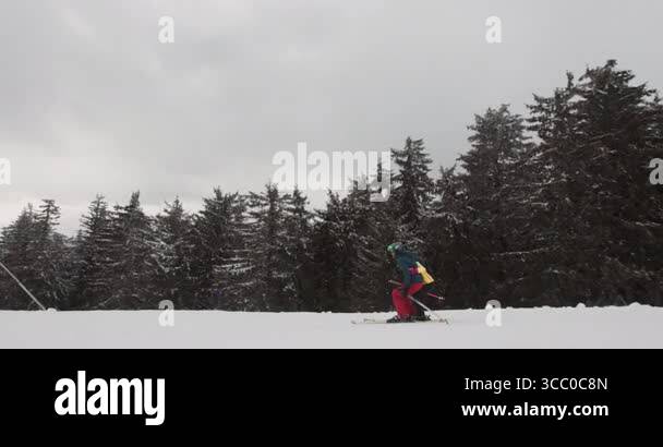 A skier expertly navigates the powdery snow on a mountain slope under a ...