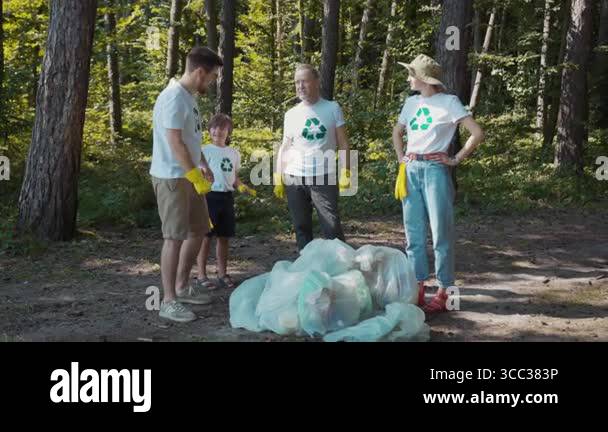 In this video, individuals gather in woods to confront littering and ...