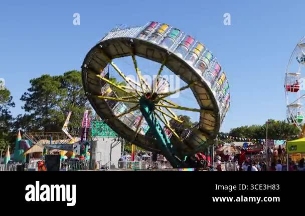 Spinning ride at a lively amusement park Stock Video Footage - Alamy