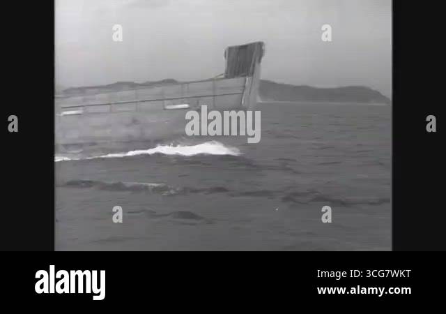 WONSAN - 1950 - An aircraft flies over a landing craft sailing towards ...