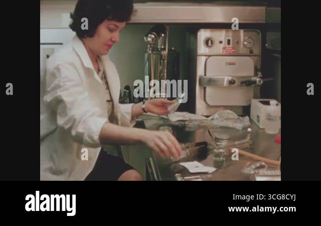 Oak Ridge Experiments OAK RIDGE - 1964 - A scientist opens her materials for an experiment ...