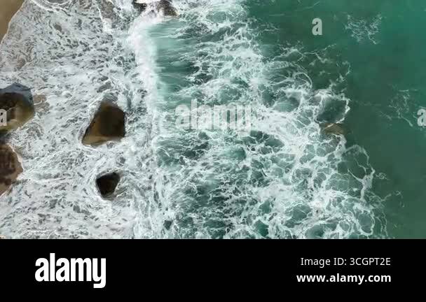 Giant ocean waves crashing and foaming on empty sand tropical beach ...
