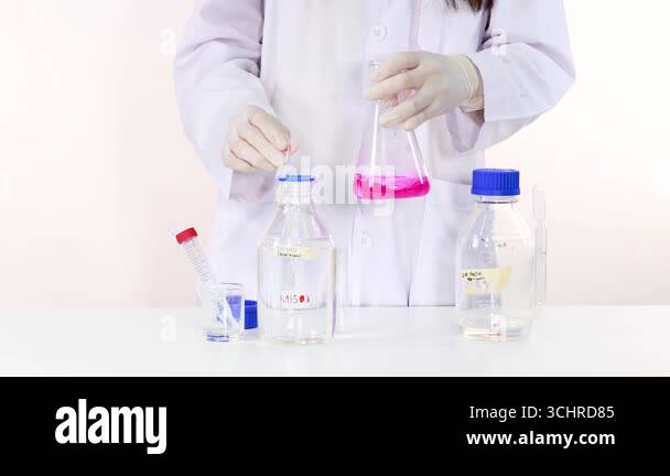 Observing color change in a chemical reaction Stock Video Footage - Alamy